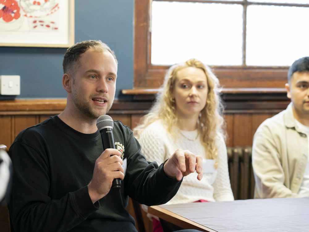 People at Skills For Growth Event 2023, with delegate speaking into microphone