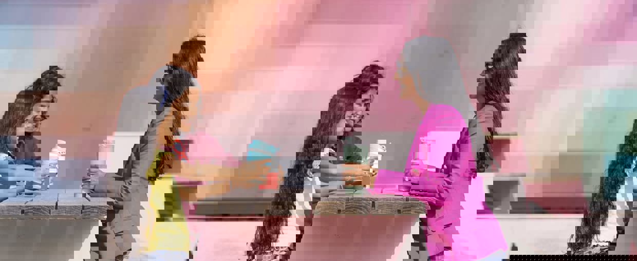 Family sitting on bench together outside Bradford interchange 