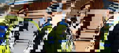 Police officers speaking together and smiling in Leeds bus station 