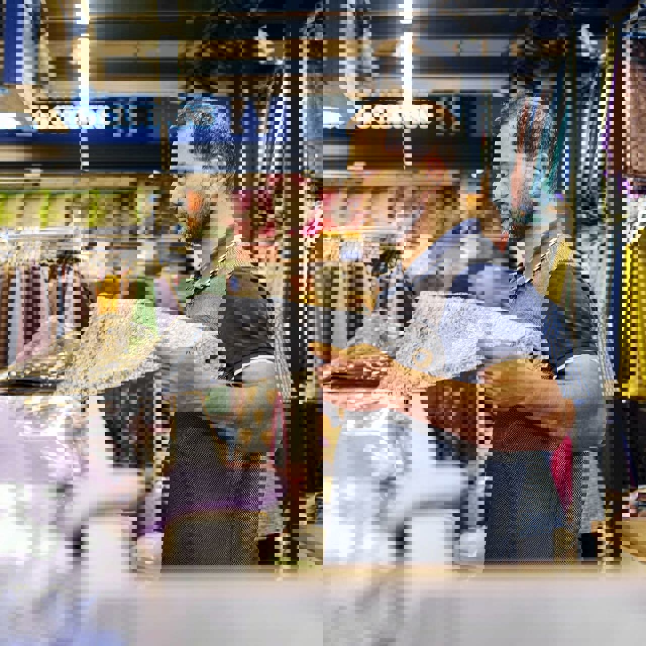 Man measuring out material at fabric shop
