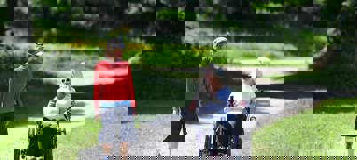 Two People Walking And Wheeling In Park 2023