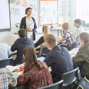 Teacher stands in front of a classroom of students