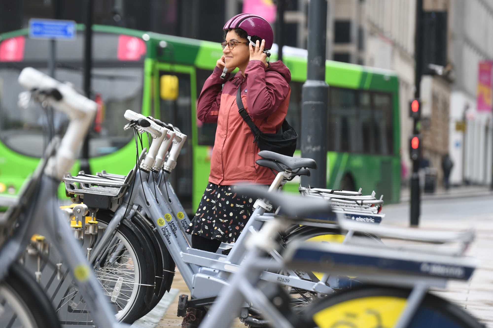 Woman next to Leeds City bikes stand