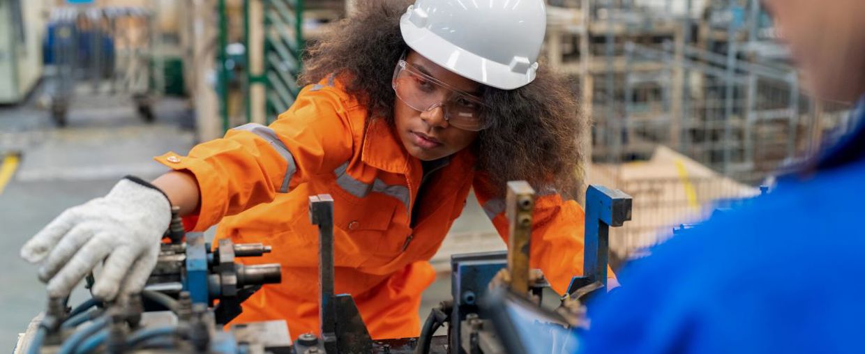 Female electrical engineer checking manufacturing parts