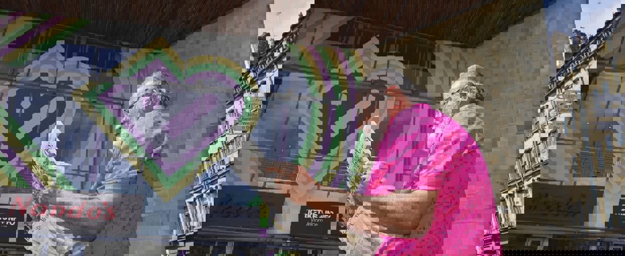 Man reading paper outside Bradford culture building