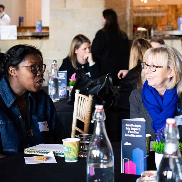 Two Women Talking At The Fair Work Charter Event 2025