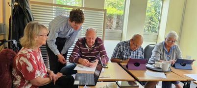 A group of people elderly people using tablets