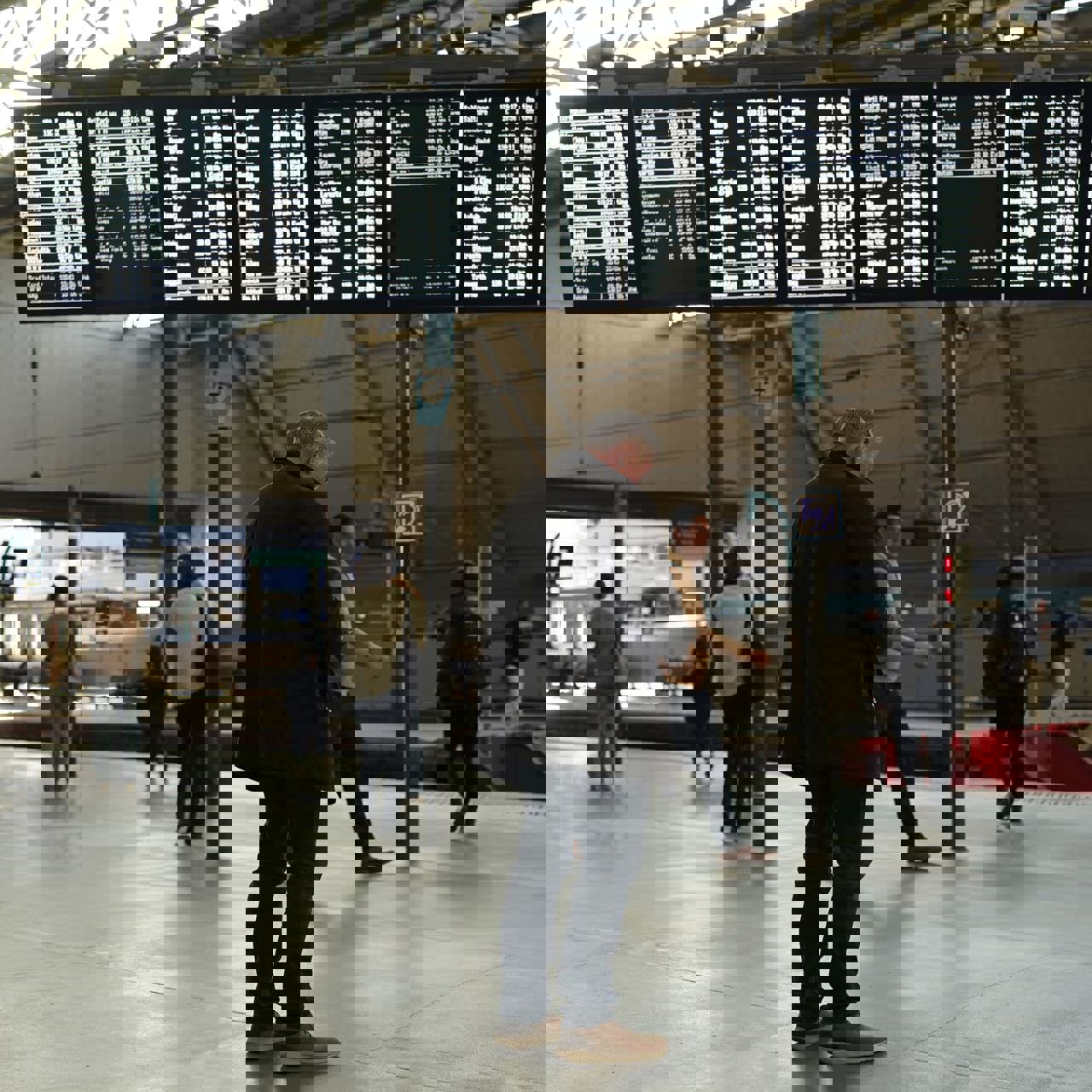 Man Standing In Leeds Train Station