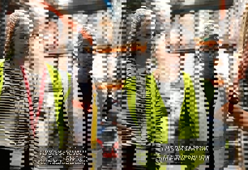 Still from SEND Employer Toolkit Video. Two women in high vis safety wear walk through warehouse