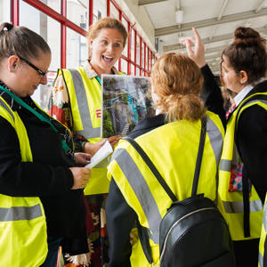 Children wearing hi-vis at bus station for engagement on consultations
