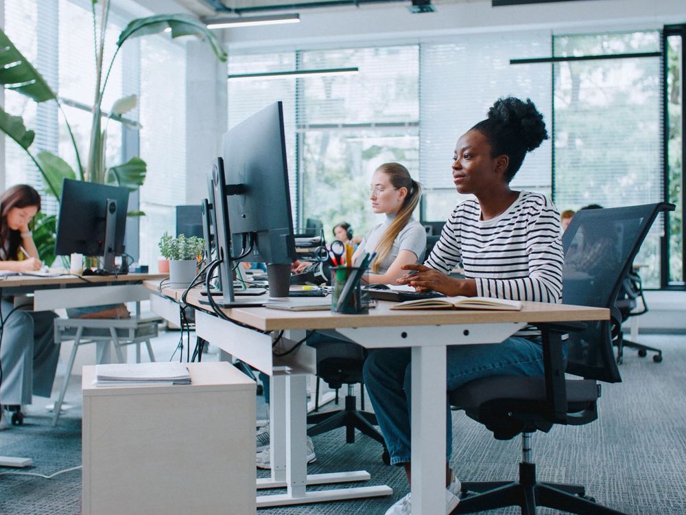 People Working At Computers In An Office