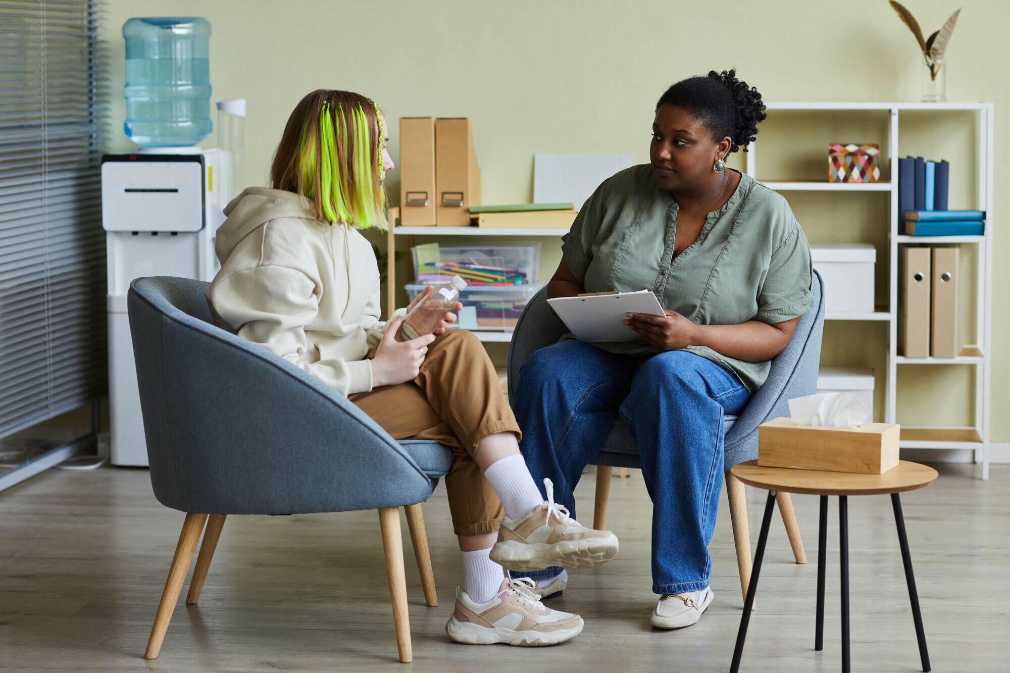 A teenager in conversation with a supportive adult