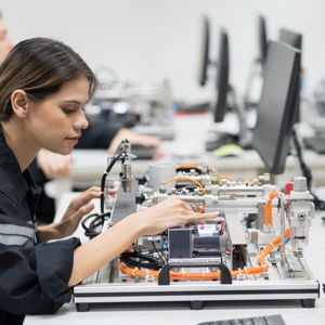 Female Engineer Training Programmable Logic Controller In The Laboratory Room